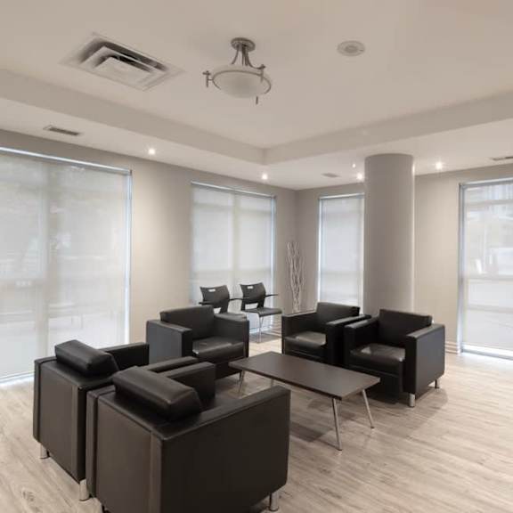 a room filled with black chairs and a table