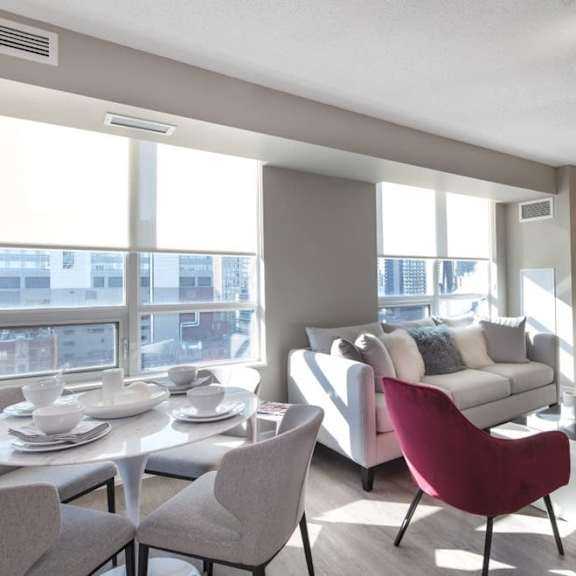 a living room filled with furniture and a large window