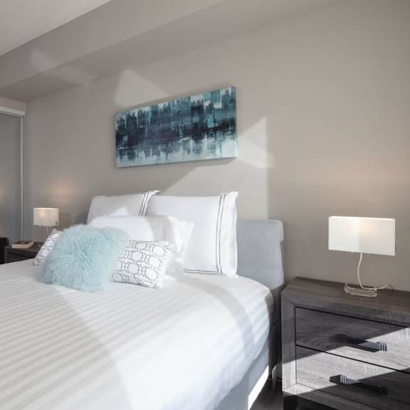a bedroom with a large bed and a mirror