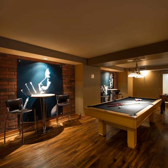 a game room with a pool table and a foosball table