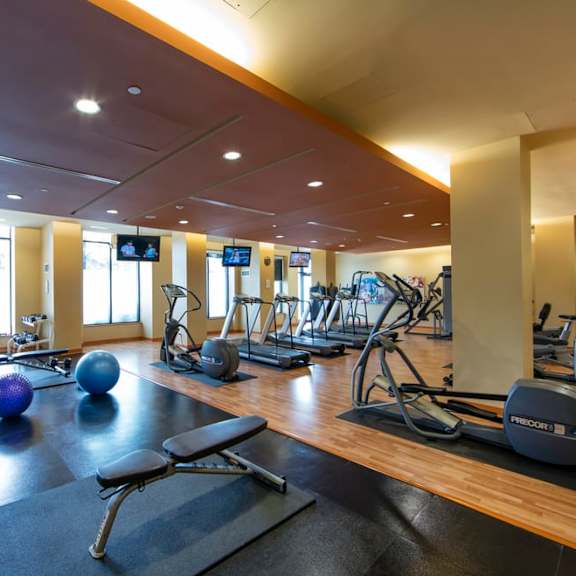 a spacious fitness center with treadmills and other exercise equipment