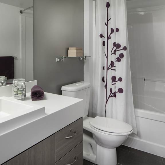 a bathroom with a white sink and toilet next to a white bathtub