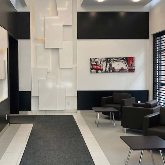 a living room with black and white walls and a white wall with a picture on it