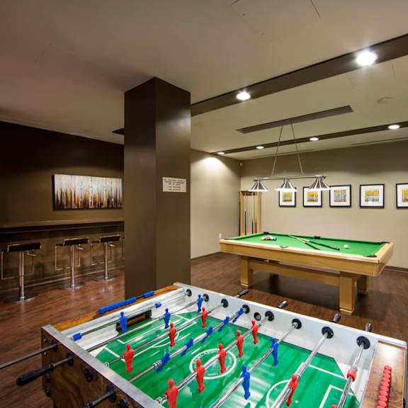 a games room with a foosball table and a ping pong table