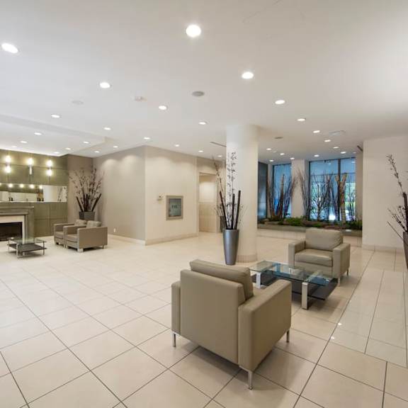 a lobby with couches and chairs and a fireplace