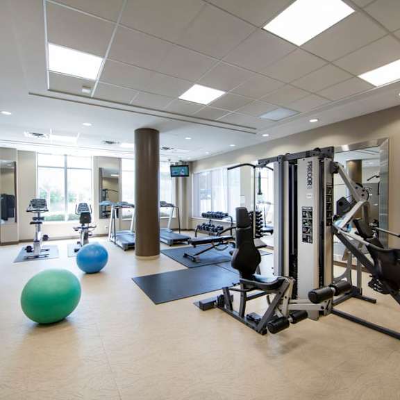 a workout room with weights and other exercise equipment at the m on hennepin apartments