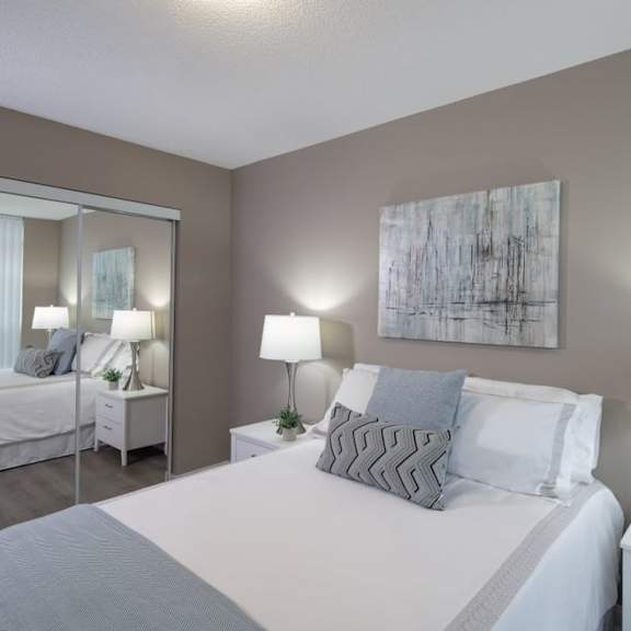 a bedroom with a bed and a mirror