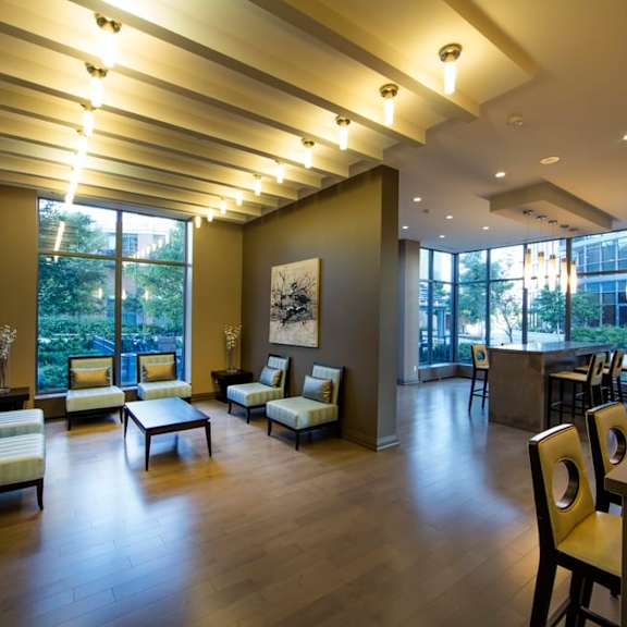 a room with couches chairs and a table in front of a large window