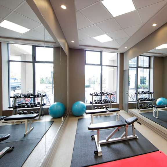 a fitness center with yoga mats and exercise equipment