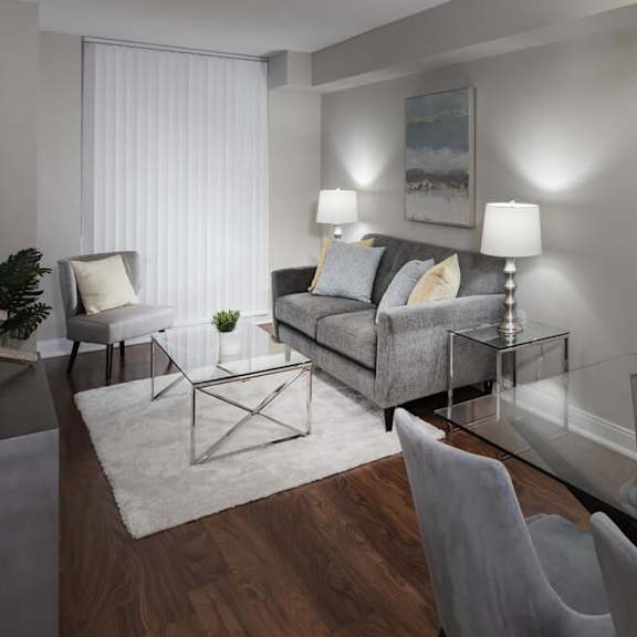 a living room filled with furniture and a large window