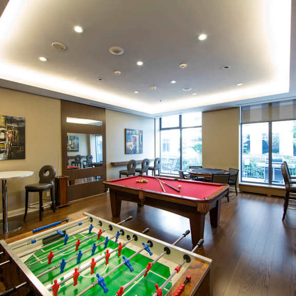 a game room with a foosball table and a ping pong table