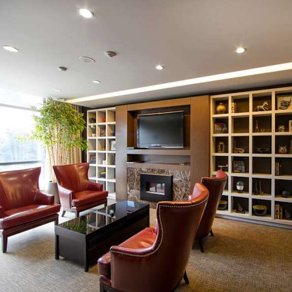 a living room filled with furniture and a large book shelf