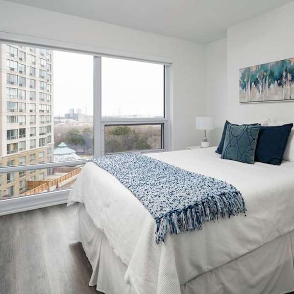 a bedroom with a large bed and a large window