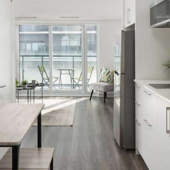 a kitchen and dining room with a large window