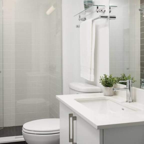 a bathroom with a toilet sink and shower