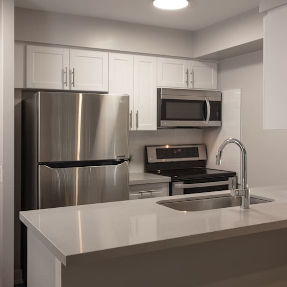 a kitchen with a sink and a refrigerator