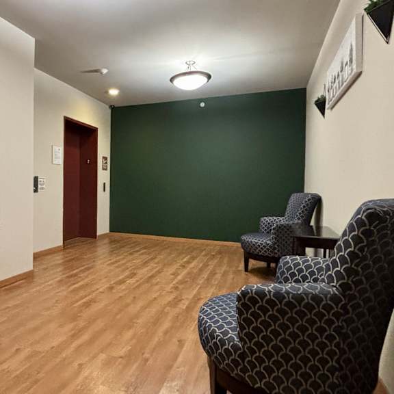 A room with a wooden floor and a chair.