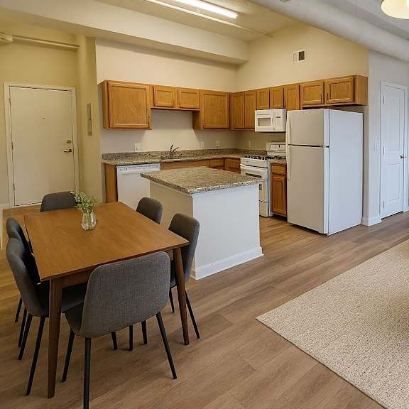 a kitchen with a table and chairs.