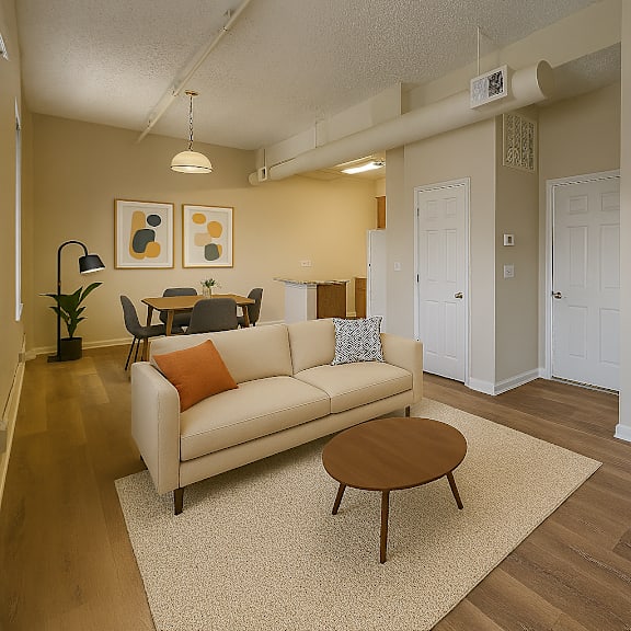 a living room with a couch, coffee table, and two doors.