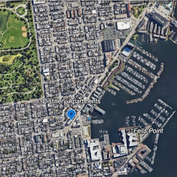 a satellite image shows a city with a large park, a marina, and a pier.