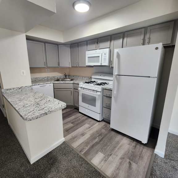 a kitchen with a granite counter top and stainless steel appliances.