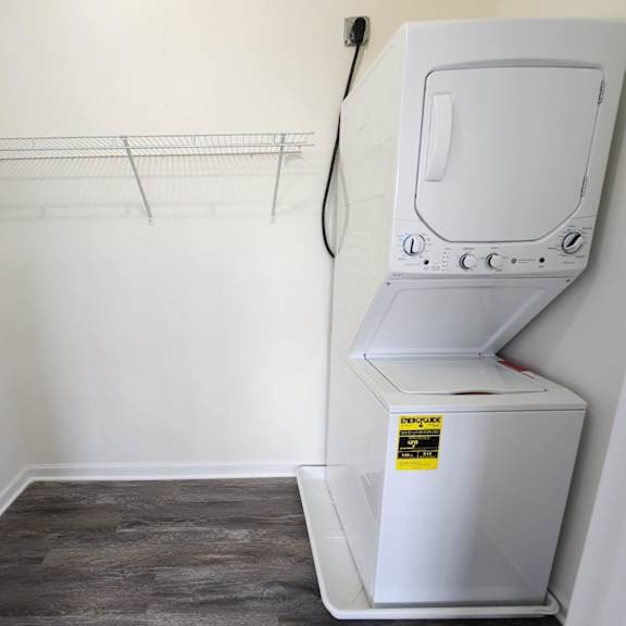 a wall-mounted dryer is in a laundry room with a clothes drying rack.