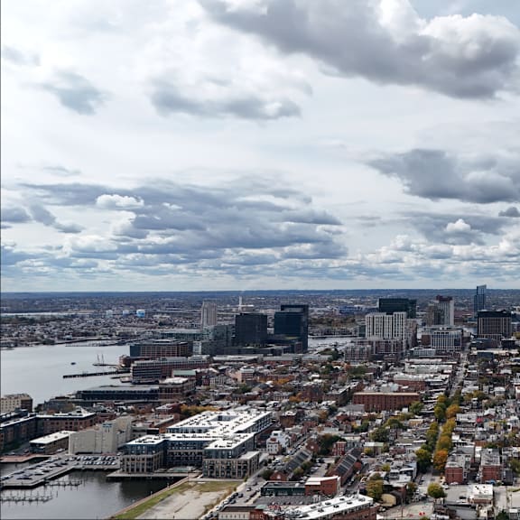 a cityscape with a cloudy sky above it.