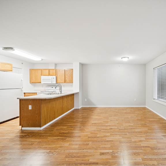 a kitchen with wooden floors and white appliances.