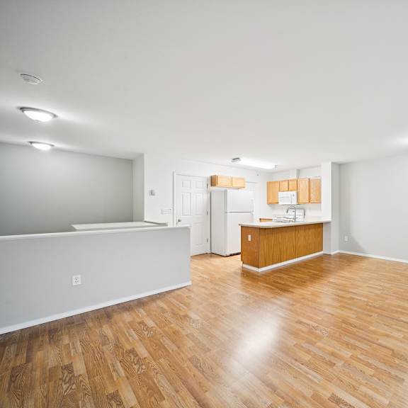 a room with wooden floors and white walls.