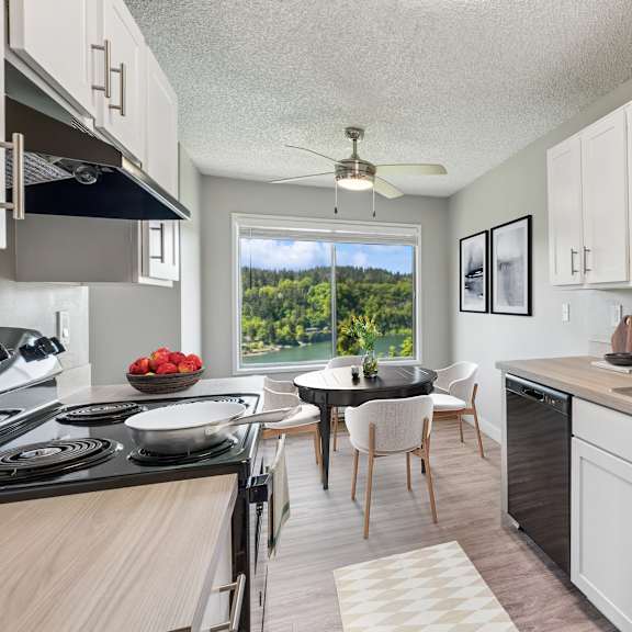 a kitchen with black appliances and white cabinets.