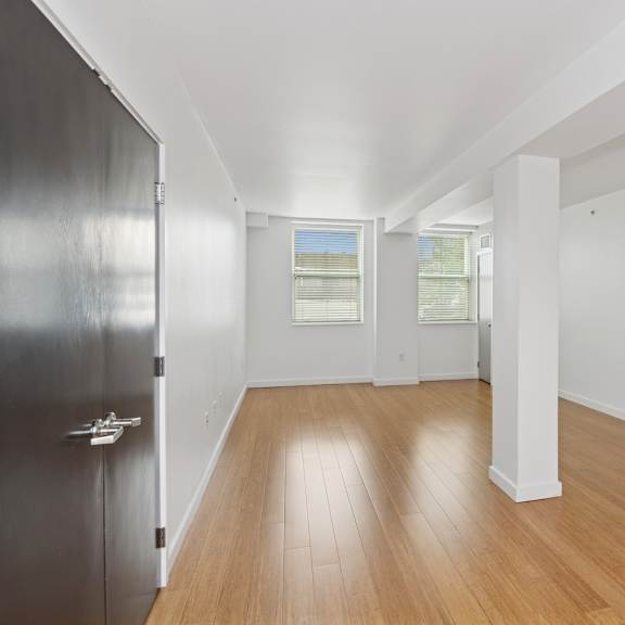 a room with wooden floors and white walls.