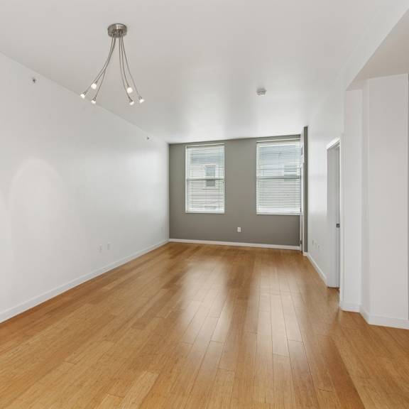 a room with wooden floors and a chandelier.