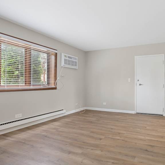 a room with a white door and a window with blinds.