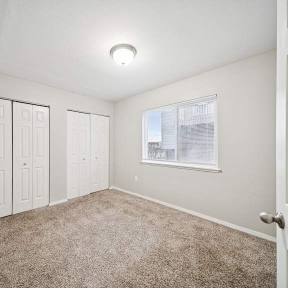 a room with white walls and a carpeted floor.