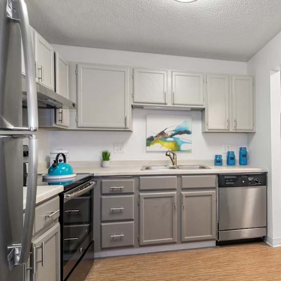 kitchen with stainless steel appliances and white cabinets