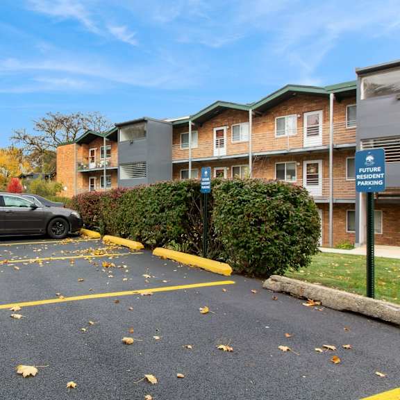 a car parked in a parking lot in front of an apartment building at river oaks, north aurora, illinois