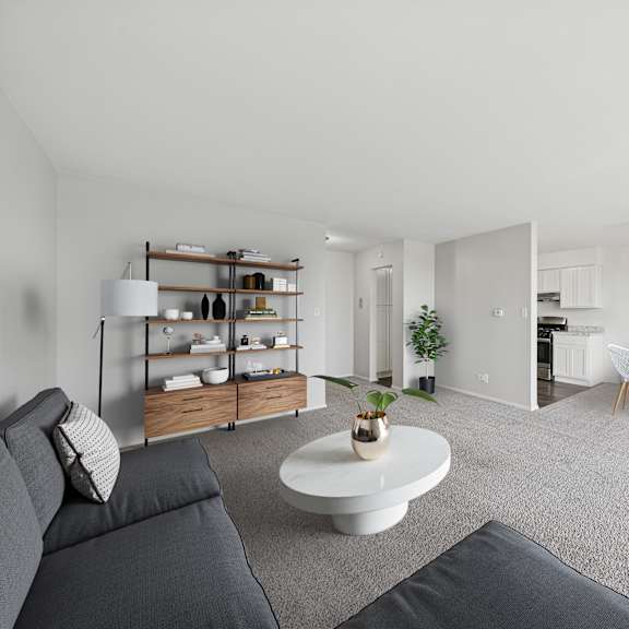 a living room with a grey sofa and a white coffee table.