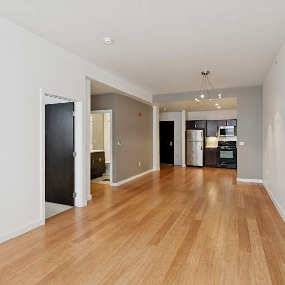 a room with wooden floors and white walls.