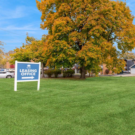 a lawn with a leasing office sign in front of a house at river oaks, illinois