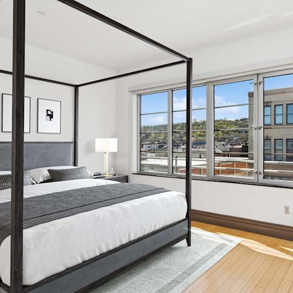 a bedroom with a large bed and a chair.
