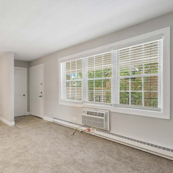 a bedroom with a large window and an air conditioner at the hinsdale, illinois, 60521