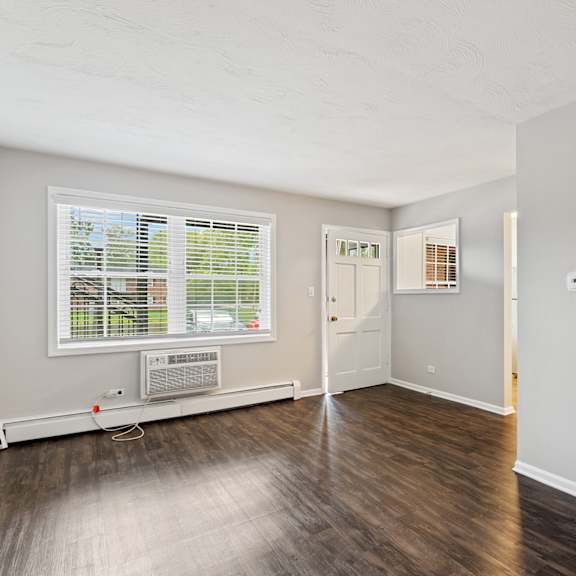a bedroom with hardwood floors and grey walls at the hinsdale, illinois