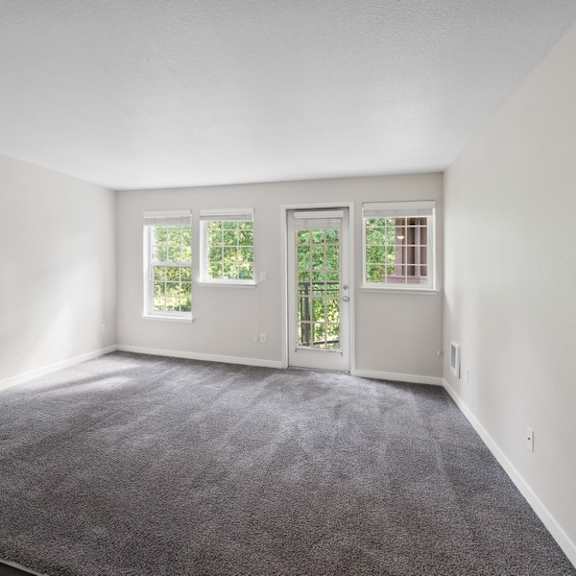 an empty room with white walls and a carpet at sundial apartments, wilsonvile, oregon