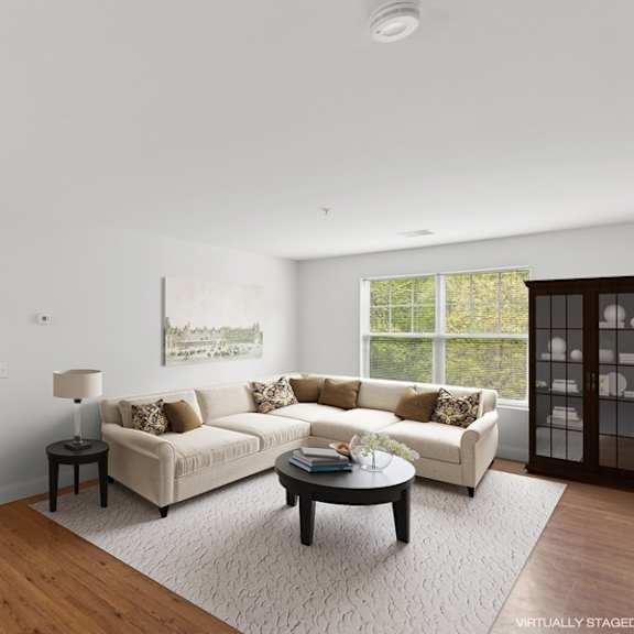 a living room with a white couch and a coffee table.