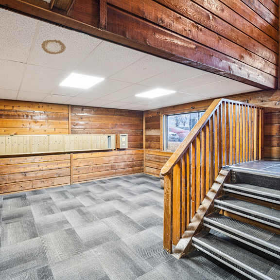 a wooden staircase with a wood railing.