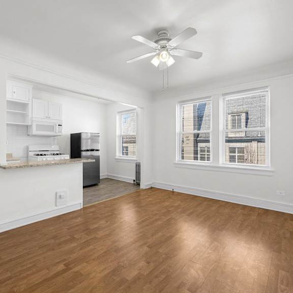 a room with a ceiling fan and wooden flooring at pleasant oak apartments, oak park, il
