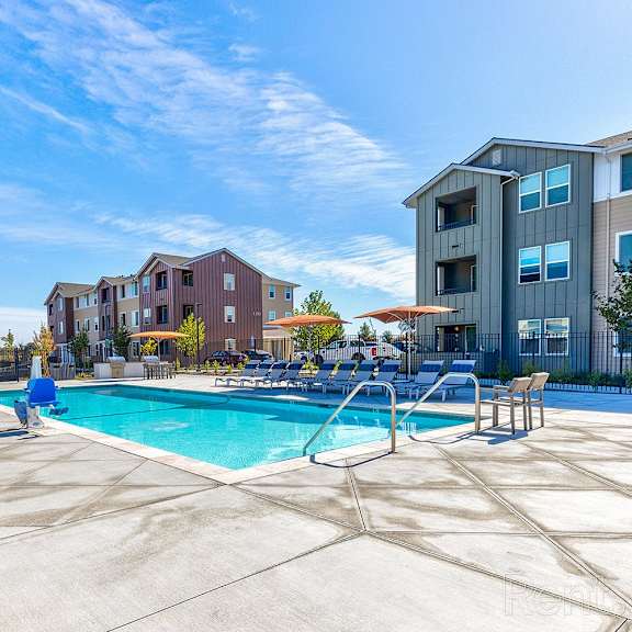 a swimming pool surrounded by apartment buildings.