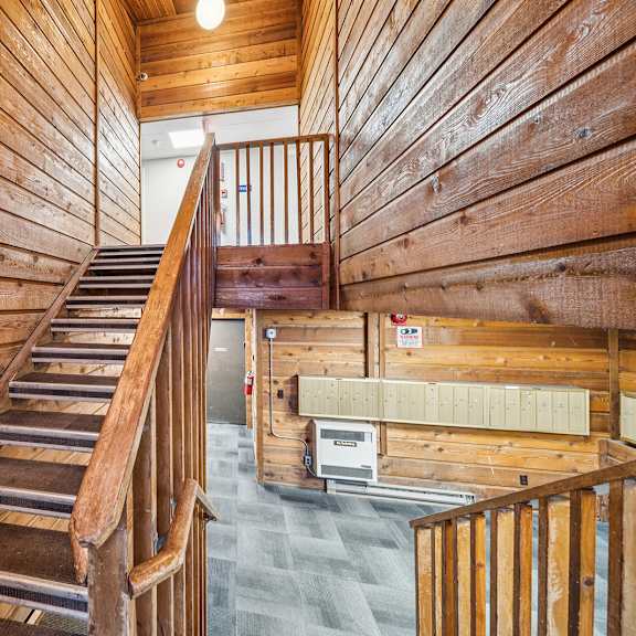 a wooden staircase in an apartment complex.