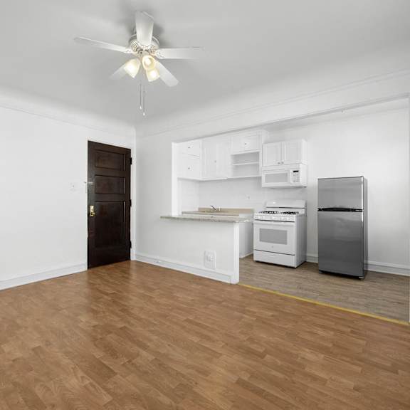 a room with a ceiling fan and a kitchenette at pleasant oak apartments, oak park