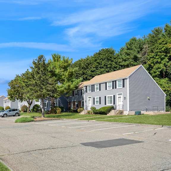 a parking lot in from of the apartments at arbor commons